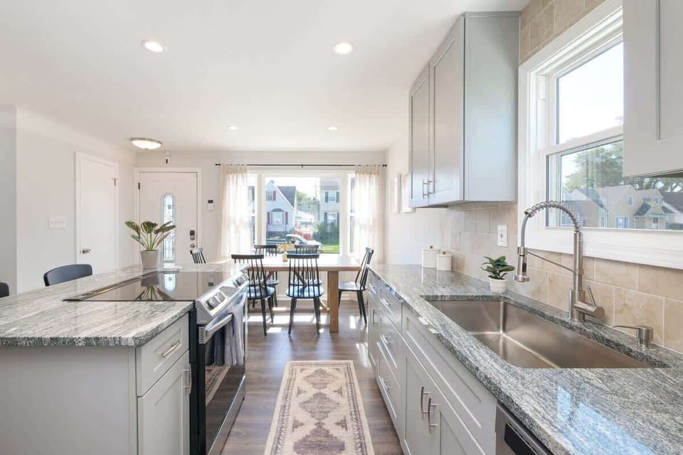Galley kitchen w/ granite counters, stainless appliances & ample prep space