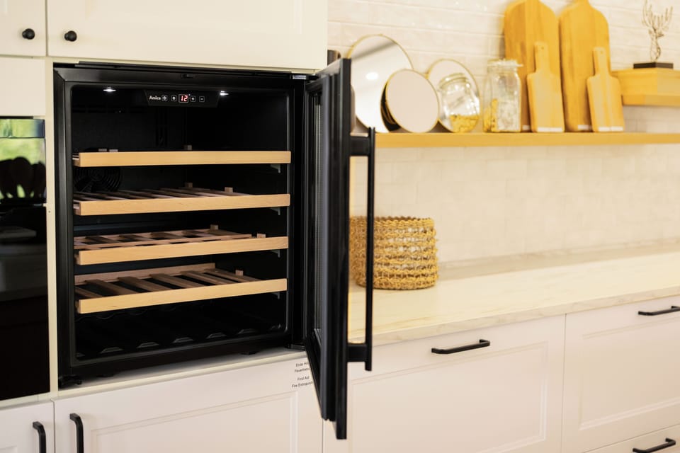 Wine fridge with wooden racks and glass door