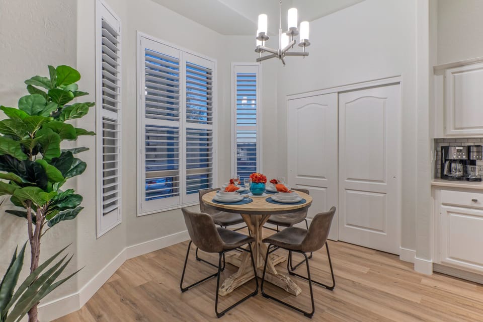 Dining area has table seating for 4 and engaging views of the backyard and park.