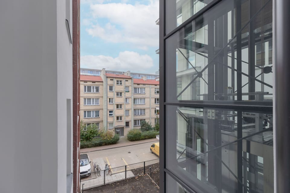 A view from a staircase overlooking the courtyard, highlighting the building’s architectural charm.
