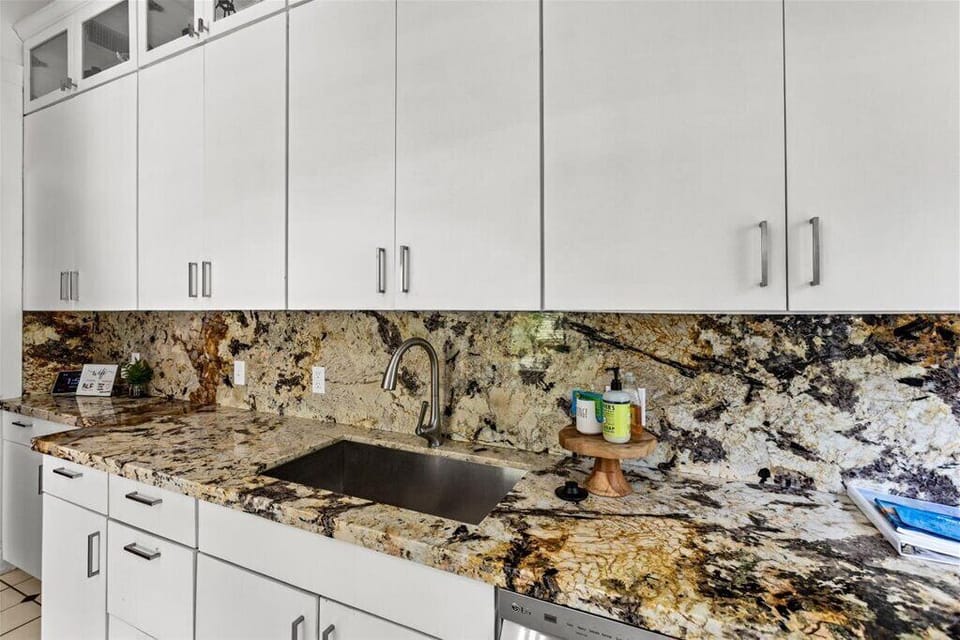 Stunning granite countertops invite culinary adventures in this airy space!