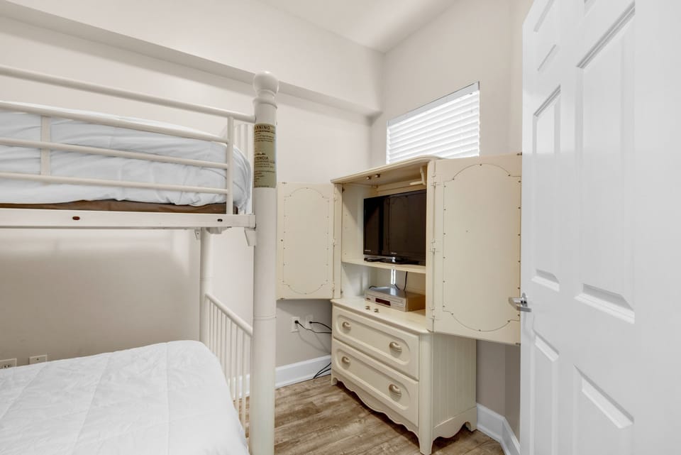 Bunk room with flat screen TV