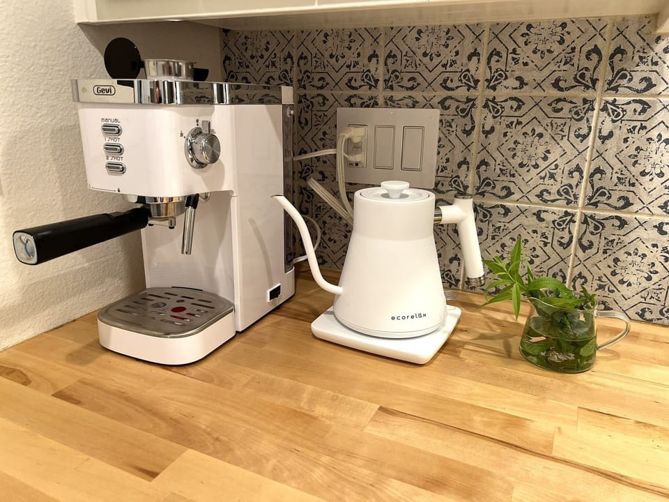 Espresso machine w Italian roast beans provided + electric kettle, teas & cocoa.