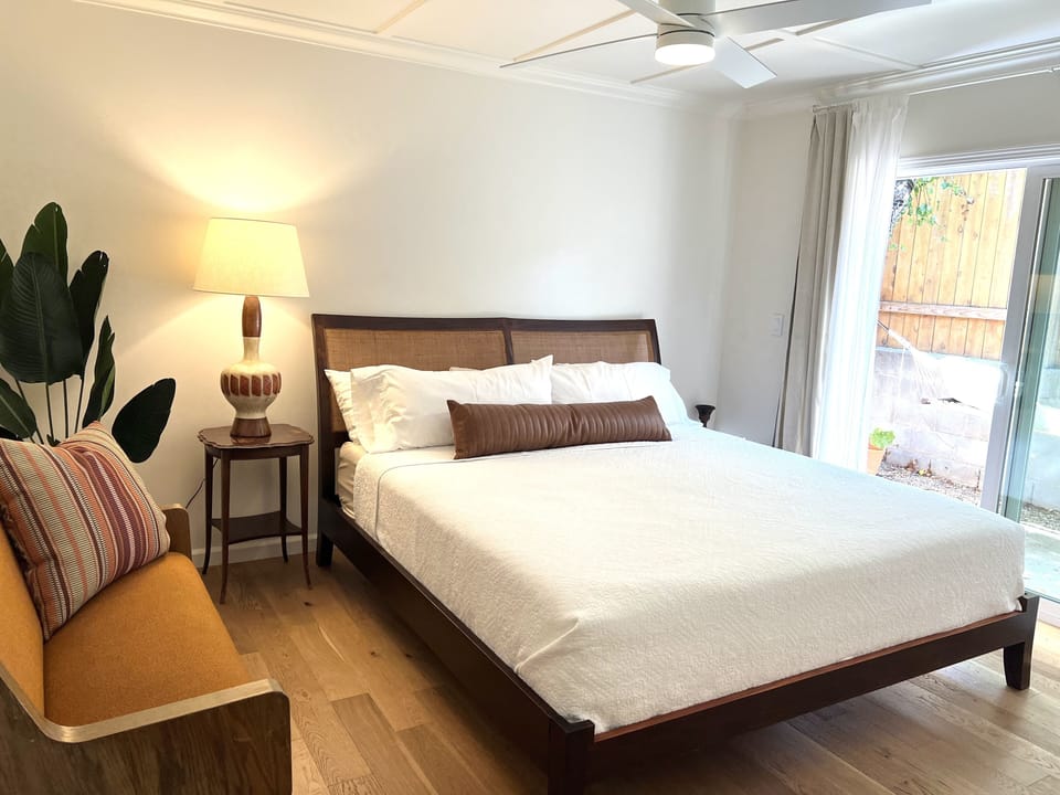 Primary bedroom has new king size Casper hybrid mattress, sliding glass doors.