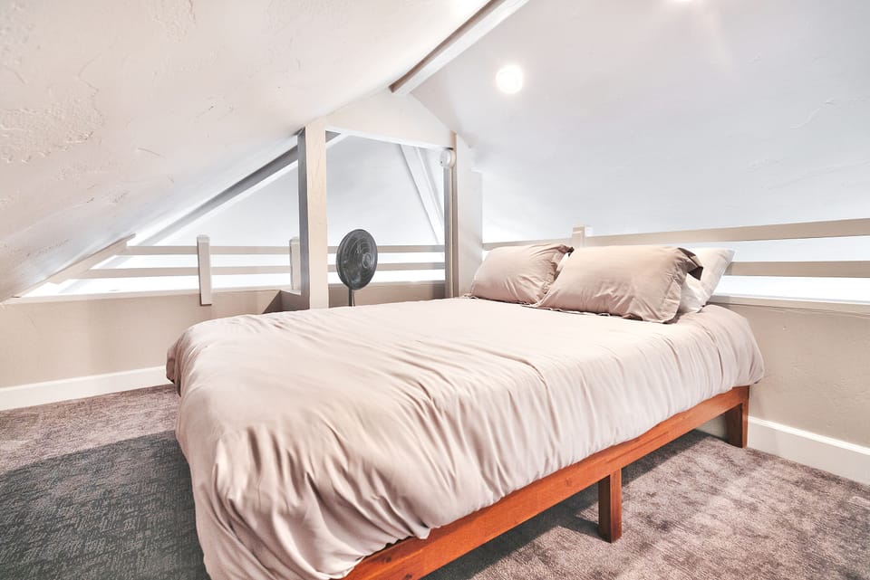 - Bright loft sleeping area with bed and soft linens  
- Angled ceiling creates a cozy and unique mountain nook  
- Relaxing hideaway for peaceful sleep during your stay
