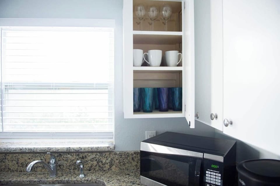 The cozy kitchen is stocked with all the supplies you will need for a home cooked meal, including dishes, pots and pans, utensils, glasses, mixing bowls and measuring supplies, Tupperware, a microwave, coffee maker, and oven.  We even have tinfoil.