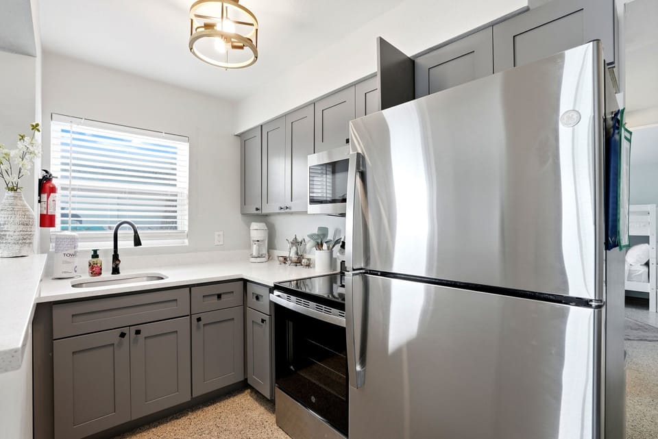 The kitchen is stocked with all the supplies you will need for a home cooked meal, including dishes, pots and pans, utensils, glasses, mixing bowls and measuring supplies, Tupperware, a microwave, coffee maker, blender and basic spices.
