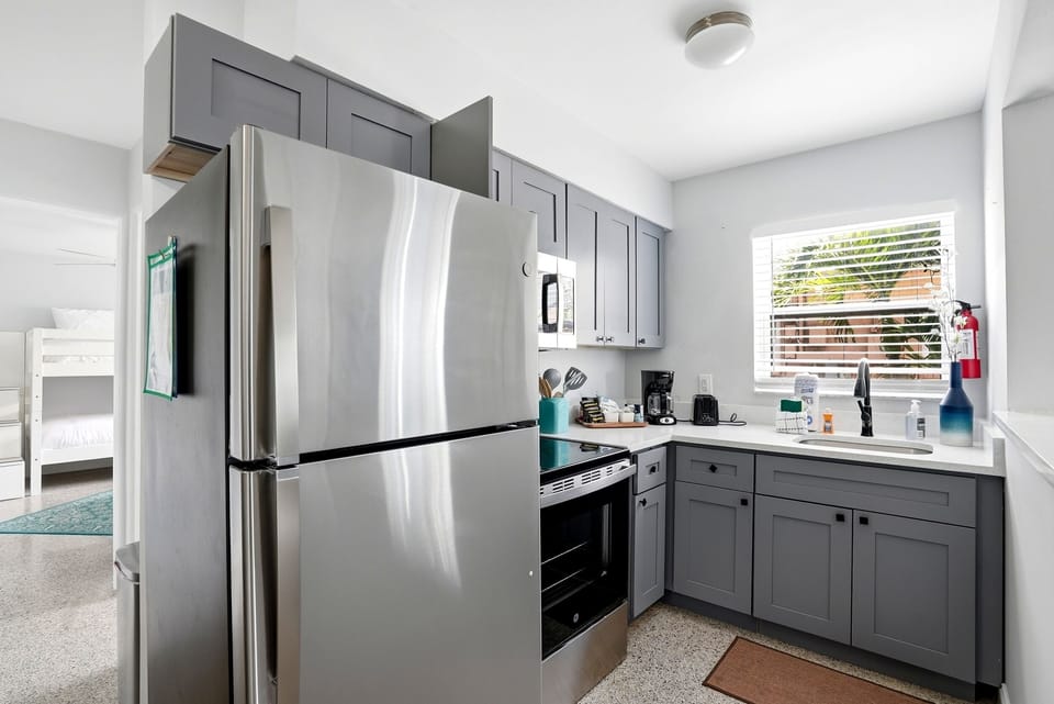 The cozy kitchen is stocked with all the supplies you will need for a home cooked meal, including dishes, pots and pans, utensils, glasses, mixing bowls and measuring supplies, Tupperware, a microwave, coffee maker (and COFFEE), and oven.  