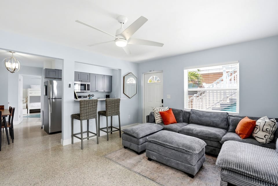 The living room and kitchen look out to the water through the master bedroom.  The extra comfortable couch is plush!