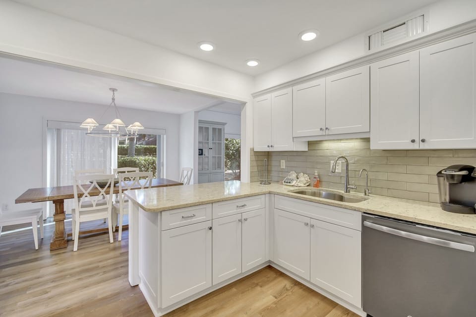 Stainless steel appliances, 2 barstools and located just off the dining room.