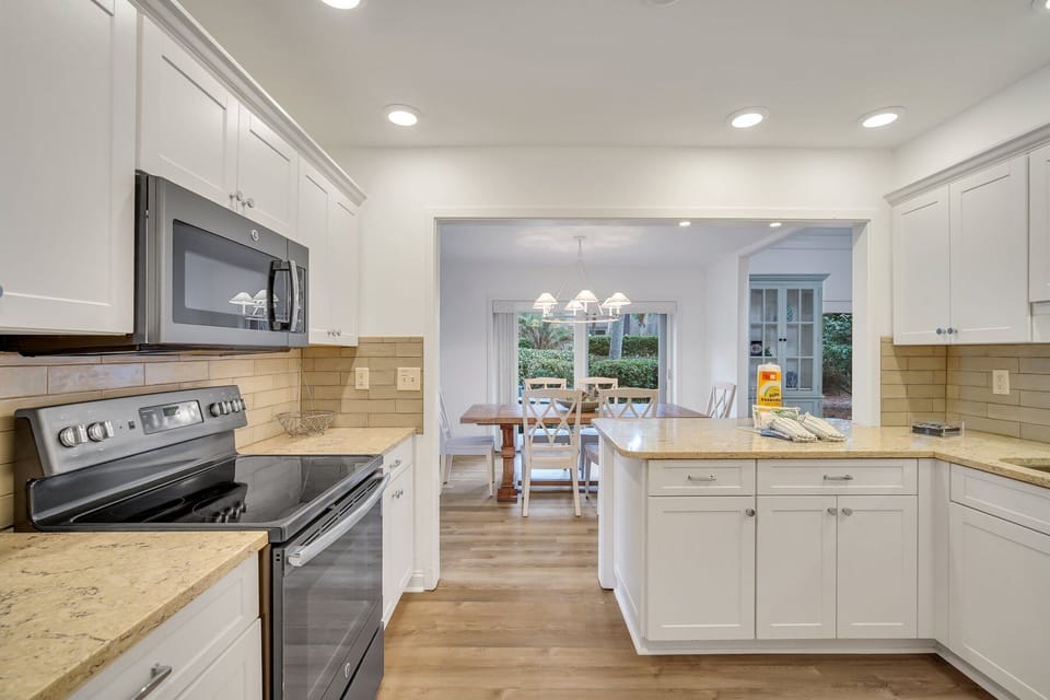 Stainless steel appliances, 2 barstools and located just off the dining room.