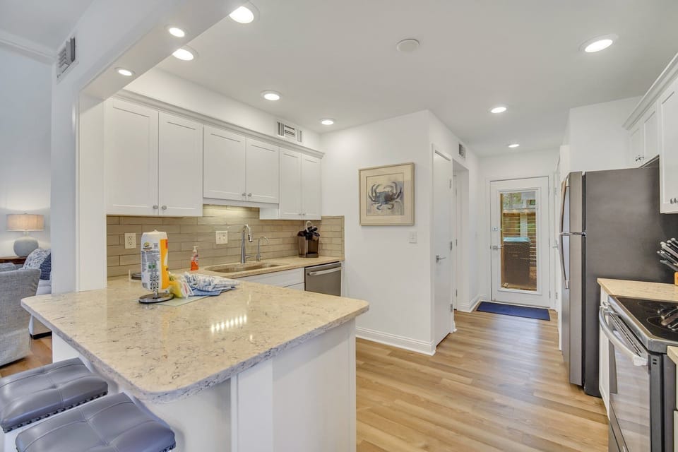 Stainless steel appliances, 2 barstools and located just off the dining room.