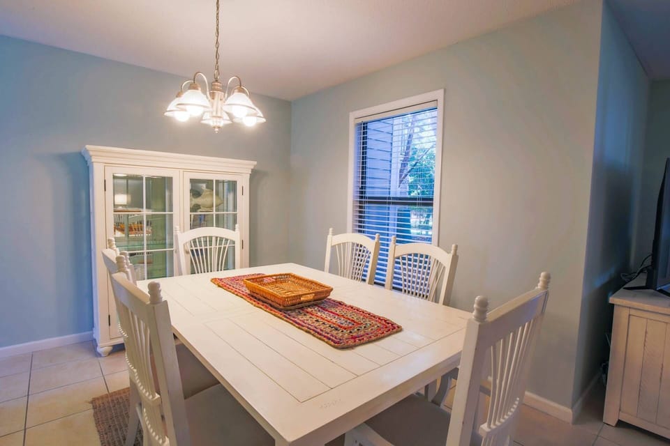 The dining room is situated between the kitchen and living room areas.