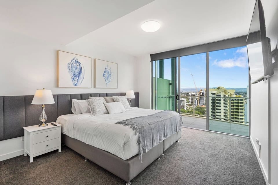 Upstairs, the main bedroom offers a king bed, TV, ensuite bathroom with a bathtub, walk-in shower, double vanity, toilet, and a walk-in robe.