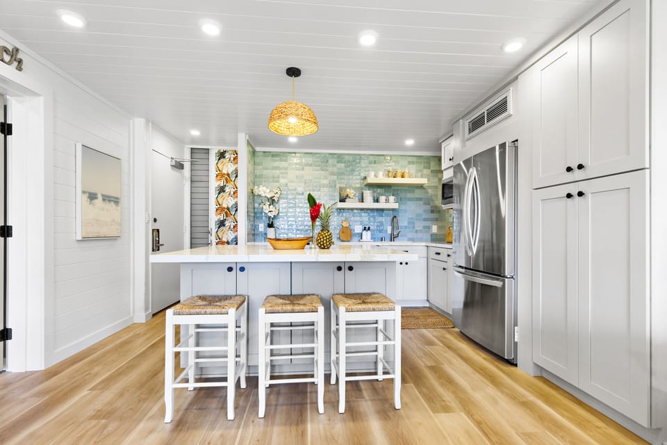 Fully Renovated Modern Kitchen - Stunning remodeled kitchen featuring quartz counters, custom backsplash, stainless appliances, and island seating for three.