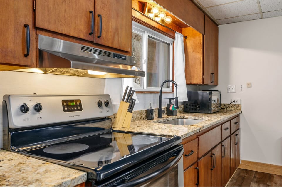 Stainless appliances and granite counters create a modern cooking space.