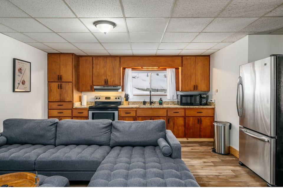 Stylish space with comfy seating, a sleek kitchen, and inviting natural light!