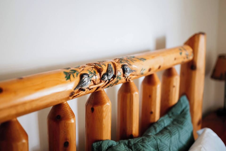 The handcrafted log headboard adds charm to this rustic retreat.