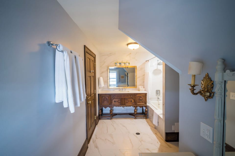 Lily Room | Bathroom | Jetted tub, rainfall showerhead, designer toiletries, hair dryer
