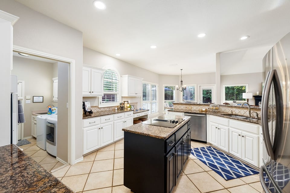 Kitchen is fully stocked with dishes, pots n pans, bakeware, and utensils. 
