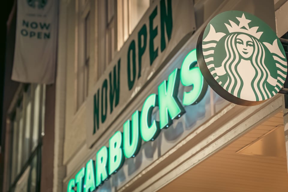 Starbucks located below lights of City Suites Logan above. Suite 4 windows shown