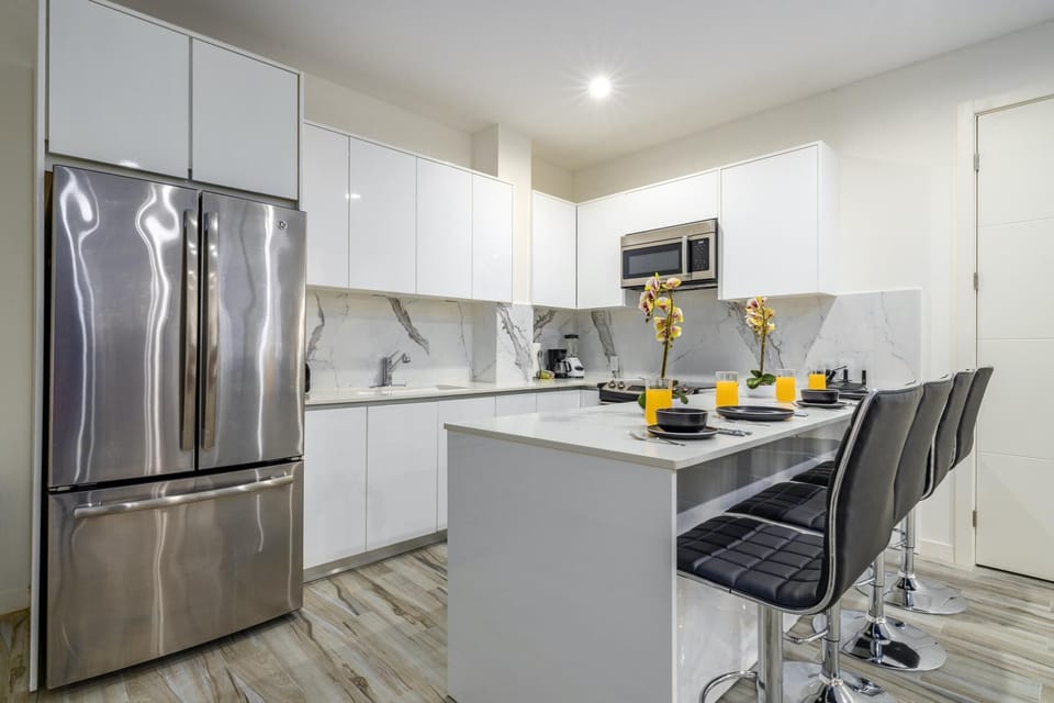 This modern kitchen/dining area brings joy into cooking and makes eating a pleasurable experience.