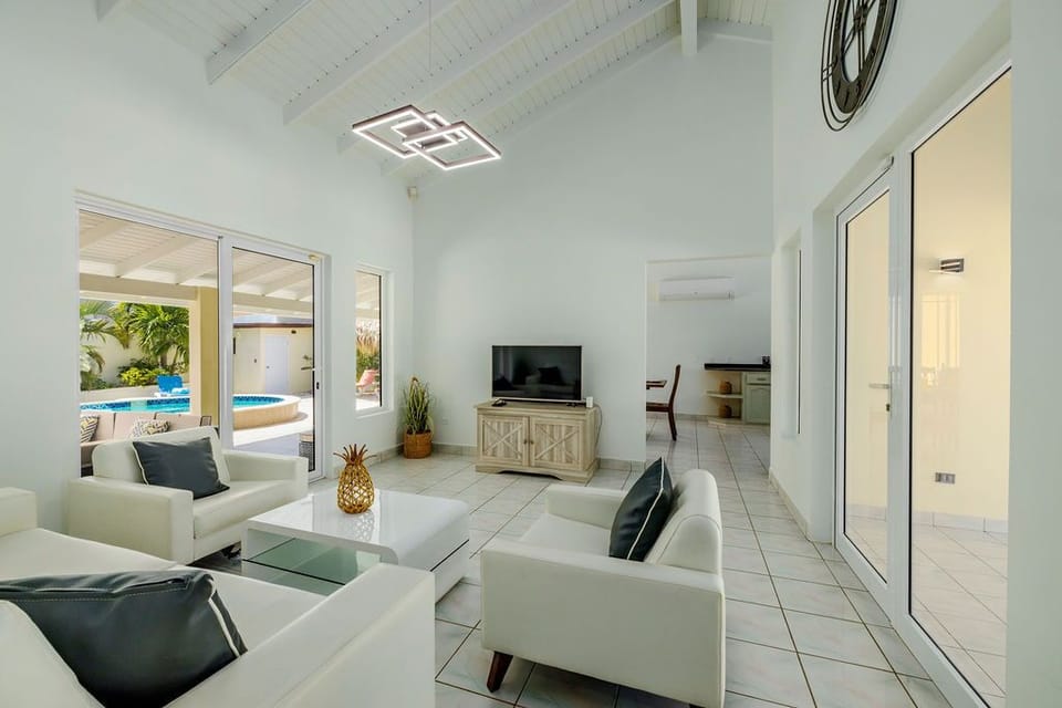 Enjoy the spacious living room with a high ceiling, spacious, and direct access to the pool area.
