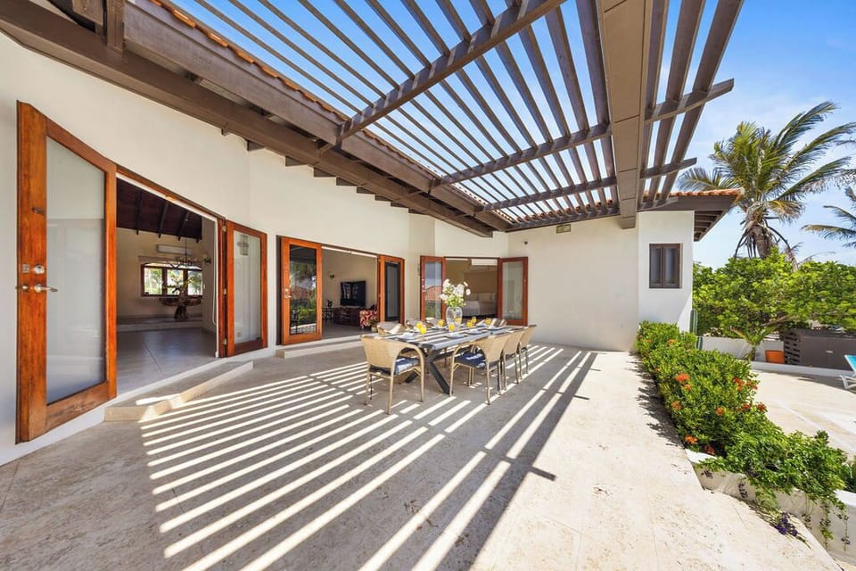 This inviting space features a stylish table and comfortable chairs, creating an ideal setting for alfresco meals, casual gatherings, or peaceful moments of relaxation.