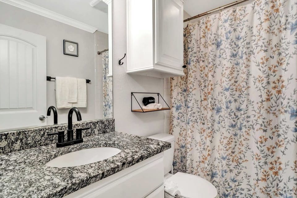 Enjoy a fresh, polished space with granite counters, modern fixtures, and thoughtful details. The warm, floral décor creates a welcoming atmosphere perfect for a relaxing retreat.