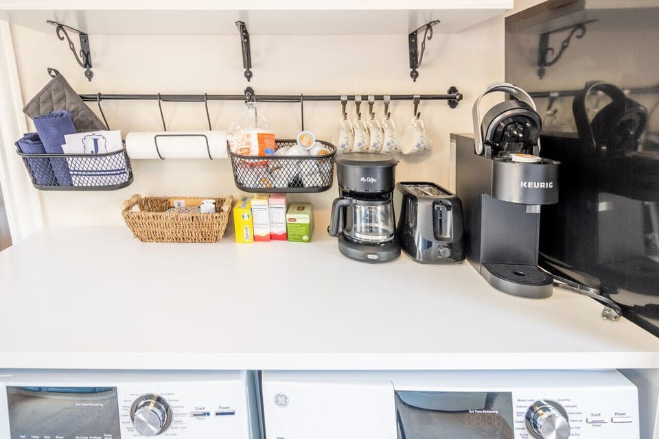 Bright, fully equipped kitchen featuring a Keurig, drip coffee maker, toaster, full fridge and freezer, oven/stove, microwave, and all the essentials you need for cooking during your private countryside getaway.
