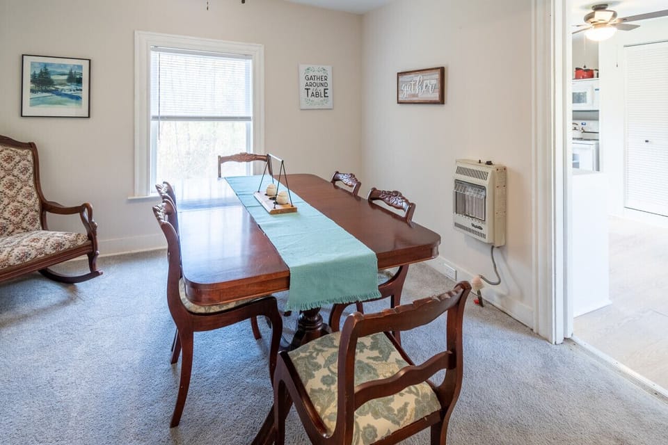 Inviting dining room with seating for six, conveniently located just off the kitchen — ideal for family meals, game nights, or planning your next adventure along historic Route 5.