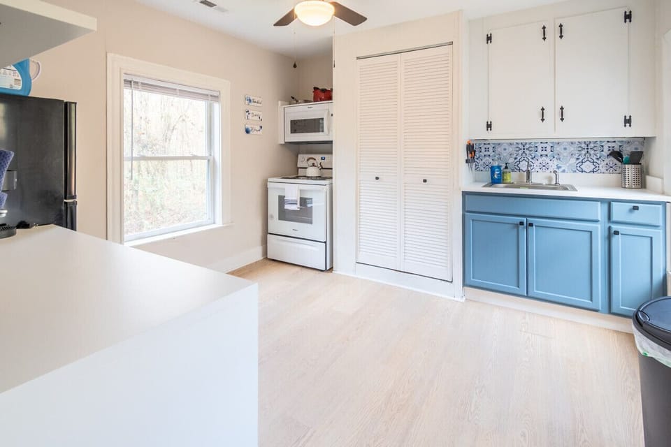 Bright, fully equipped kitchen featuring a Keurig, drip coffee maker, toaster, full fridge and freezer, oven/stove, microwave, and all the essentials you need for cooking during your private countryside getaway.
