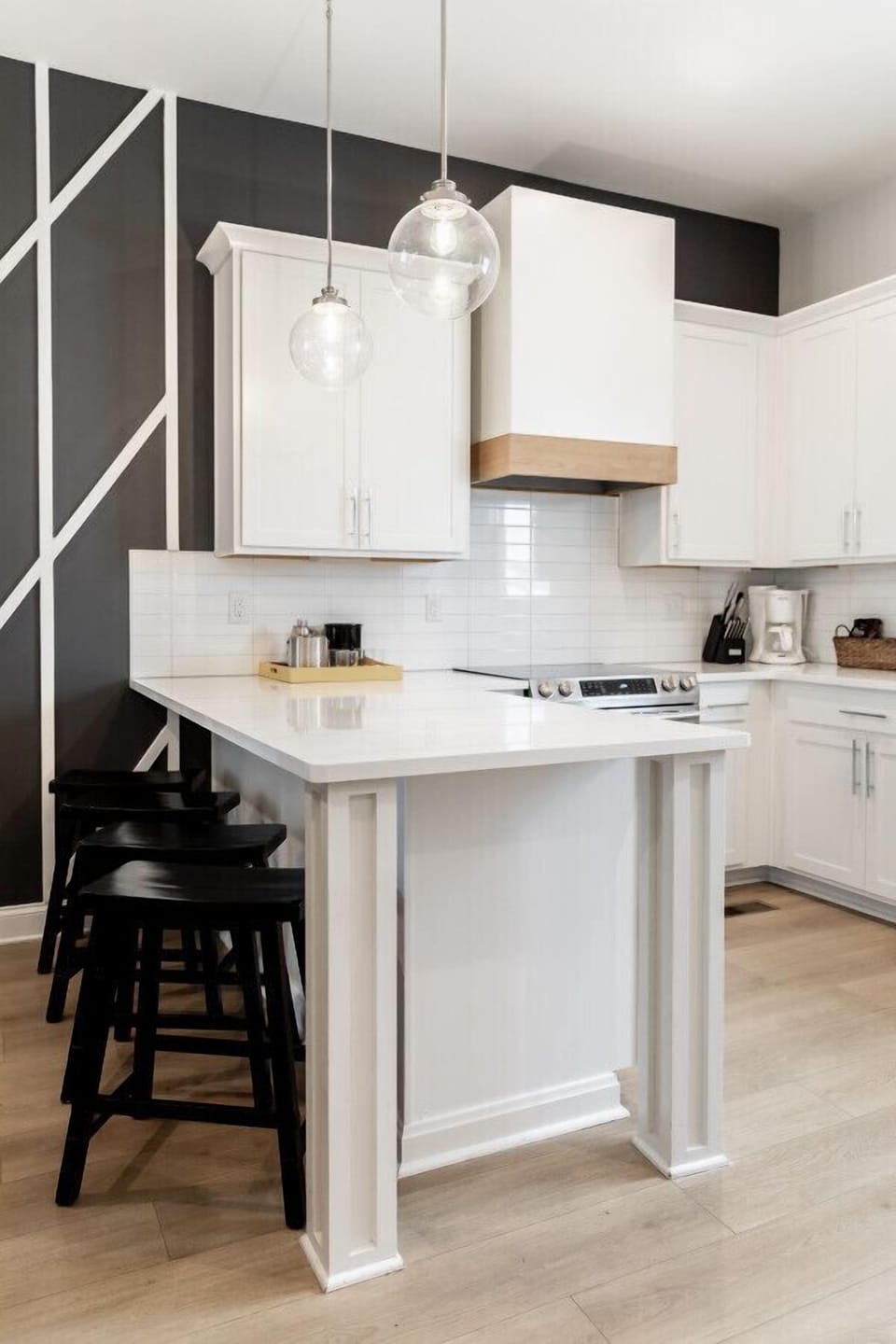 Bright, fully-equipped kitchen with seating for 4 at the counter plus a dining table with seating for 6. Opens up into the living room.