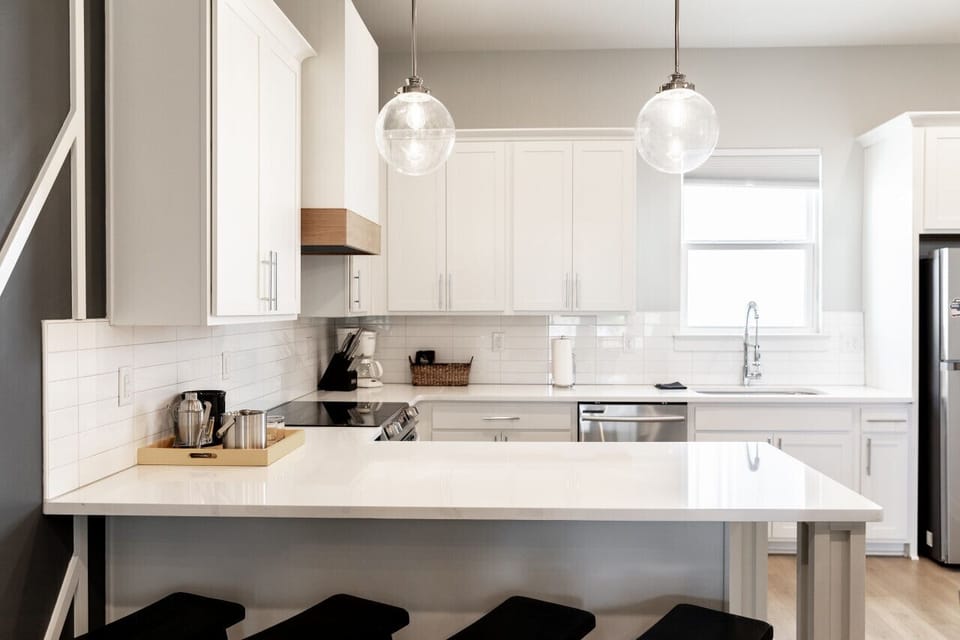 Bright, fully-equipped kitchen with seating for 4 at the counter plus a dining table with seating for 6. Opens up into the living room.