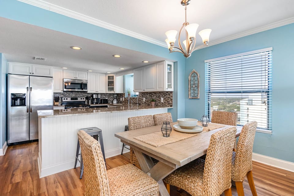 Your coastal-inspired dining space features a stunning open kitchen where you'll love preparing meals together, with wicker seating for six.