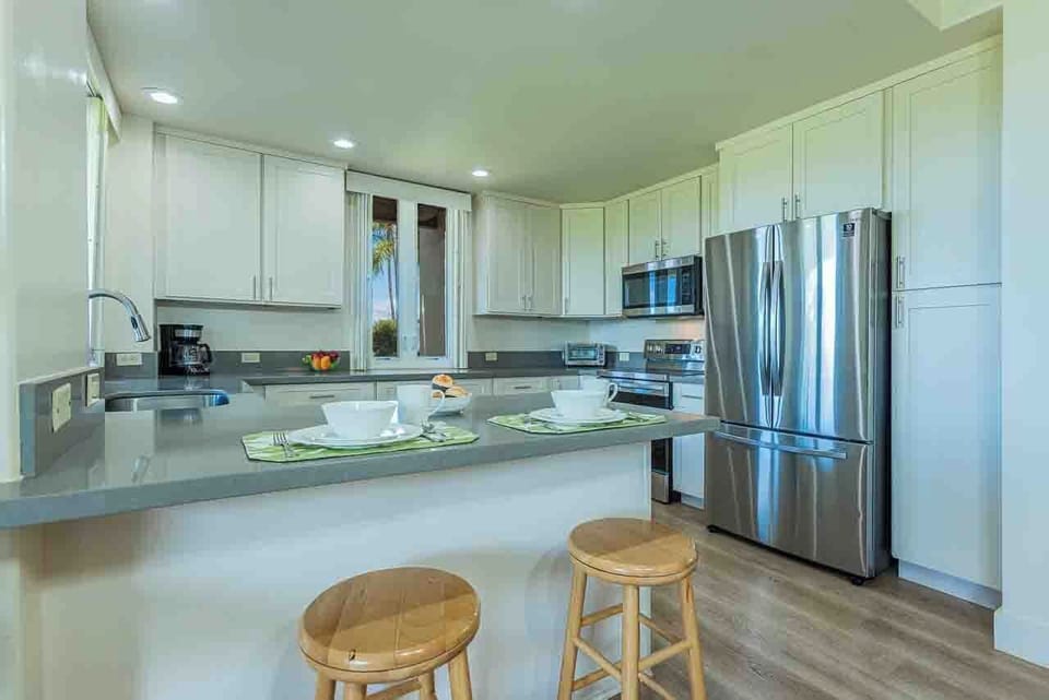 Your fully equipped kitchen with stainless steel appliances and granite countertops invites you to gather around the breakfast bar. The bright, modern space features ample storage and everything you need to prepare meals.