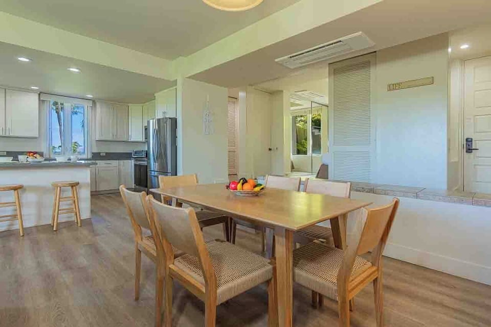 Step into your open-plan gathering space where the dining table flows seamlessly into a bright, modern kitchen—perfect for sharing meals and making memories together.