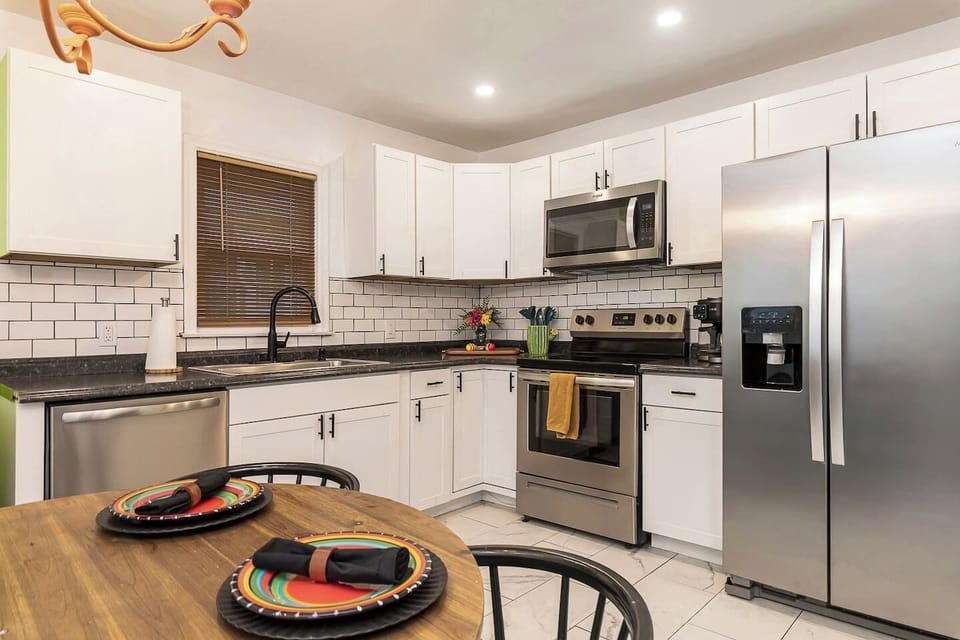 The kitchen is fully equipped with modern appliances, clean finishes, and plenty of counter space, making cooking and dining effortless during your stay.
