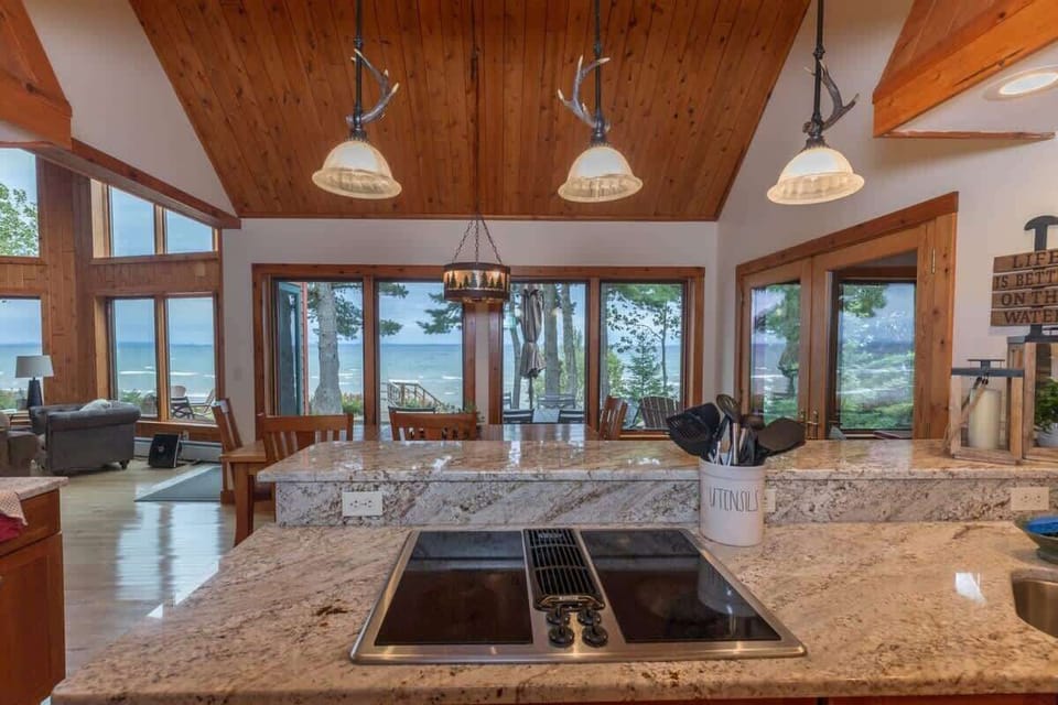 Kitchen island with an unobstructed view straight out to Lake Superior — open-concept layout keeps the group connected from kitchen to living room
