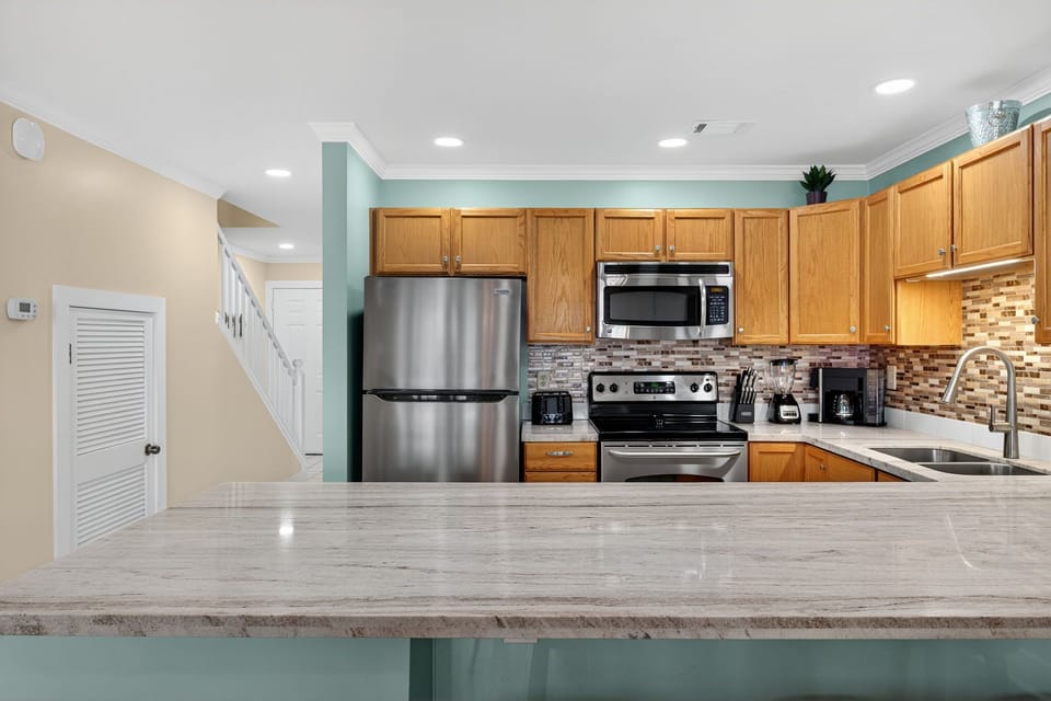 Your fully equipped kitchen features stainless steel appliances, granite countertops, and everything you need to prepare meals during your stay.