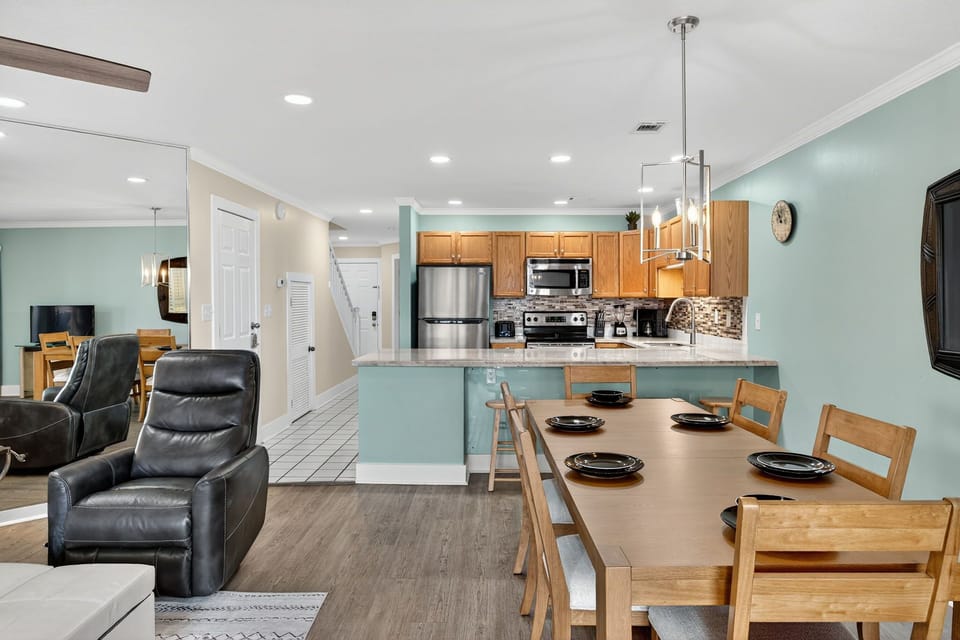 Your open-concept living space seamlessly blends comfort and functionality, featuring a fully equipped kitchen with modern appliances and a welcoming dining area for memorable meals.