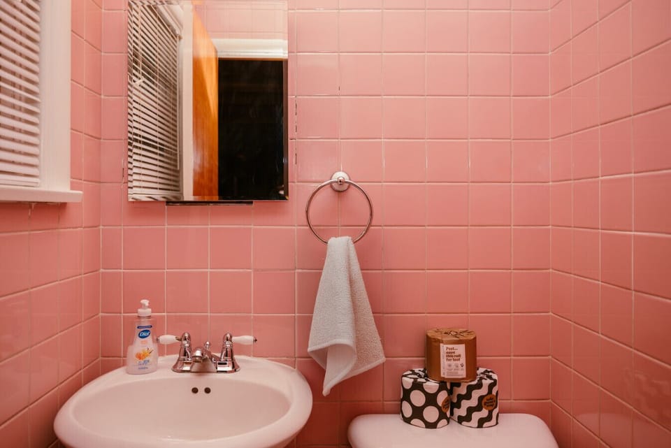 Pretty in pink- original mid-century bathroom brings all the vintage charm with a splash of sass.