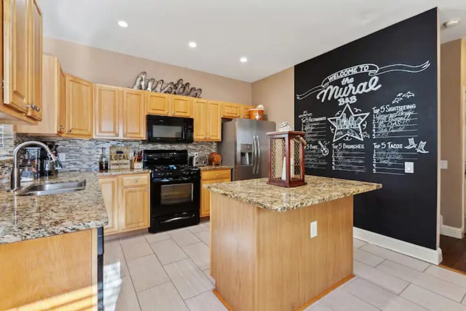 Kitchen in 1 side of the duplex has a cool "Top 5" Austin eateries Chalk Mural.