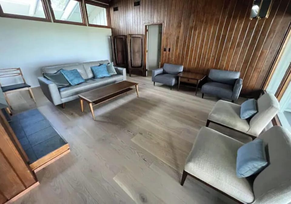 living room with cathedral ceiling, water views