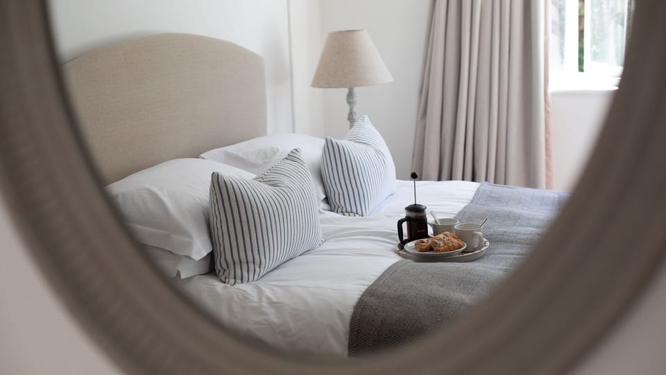 The bedroom is the perfect spot for breakfast in bed for two, Arrow Lodge.
