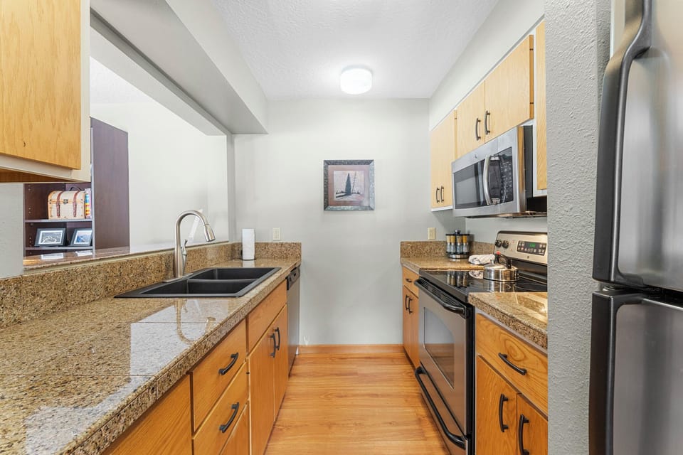 Your fully equipped kitchen awaits with granite countertops, stainless steel appliances, and everything needed for home-cooked meals.