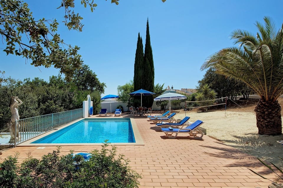 Your private pool with sun loungers. Have a game of Badminton!