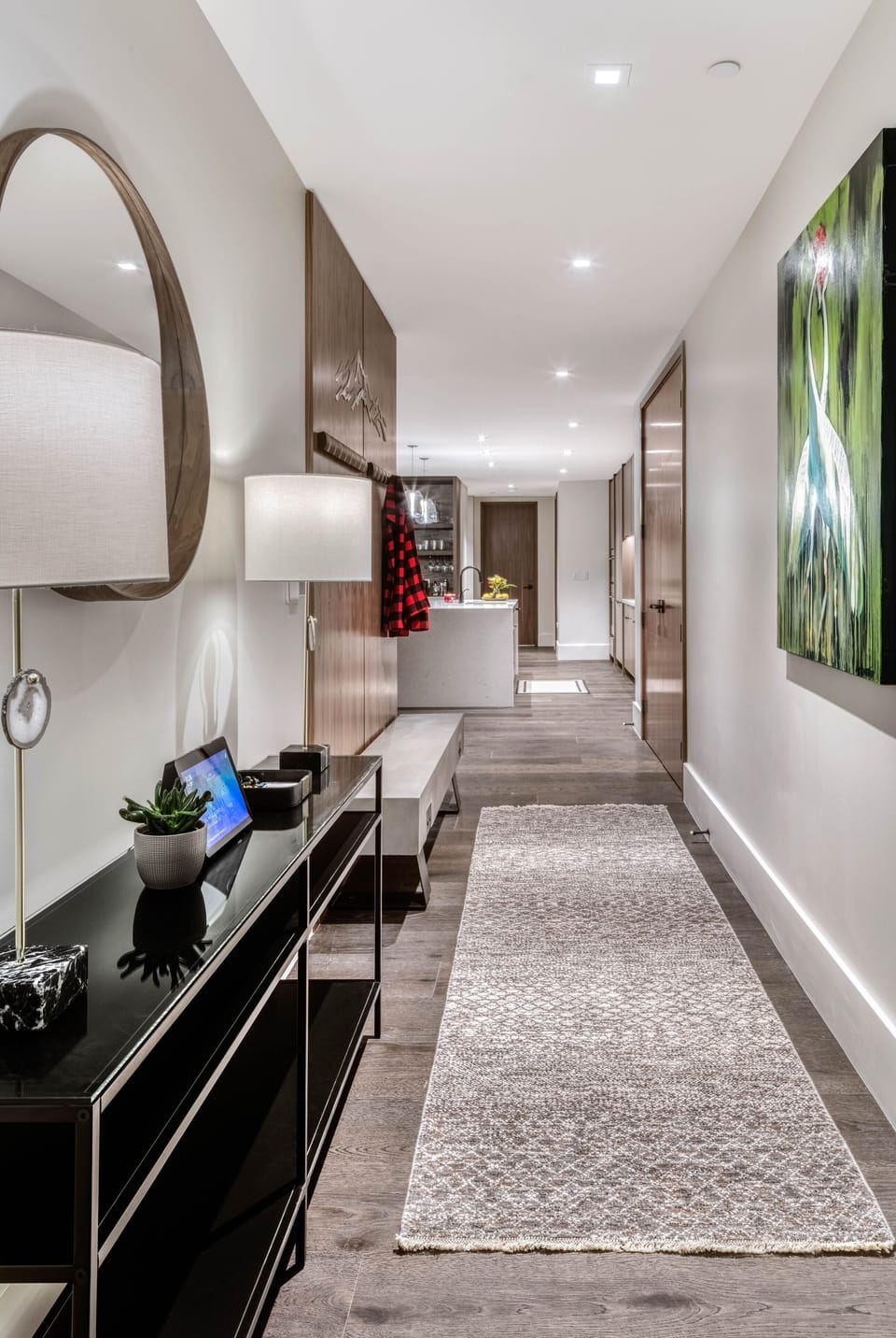 Condo entranceway w/ commissioned artwork, a place to hang jackets & more.