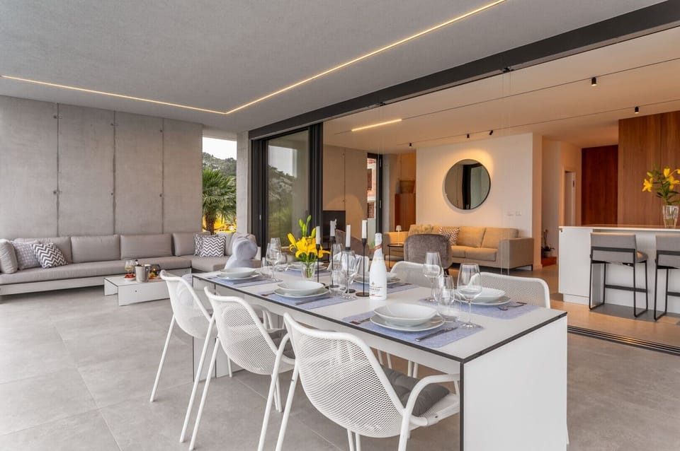 Private terrace of Croatia luxury holiday villa with outdoor dining table and lounge area for rent on Hvar island