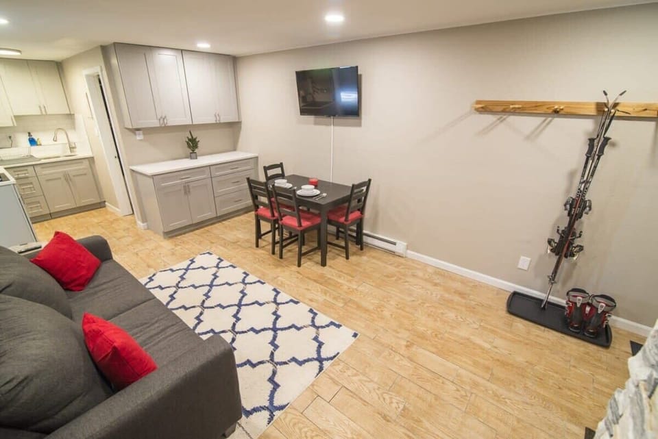 The view over the living/dining room and into the kitchen highlights the apartment’s open-concept layout fully equipped with all the necessities for a comfortable stay.